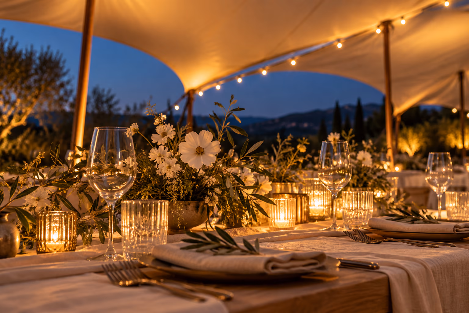 Illustration of a floral wedding tablescape beneath warm canopy lighting at dusk.