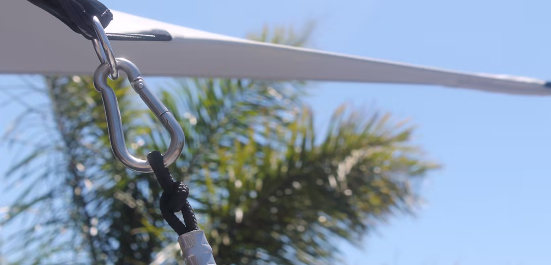 Close view of stretch tent edge hardware and tension line