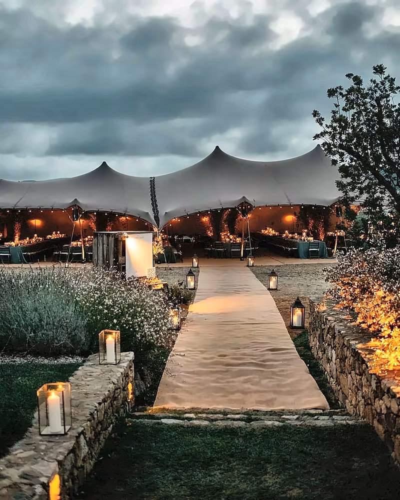 Stretch tent and stone path under a stormy evening sky