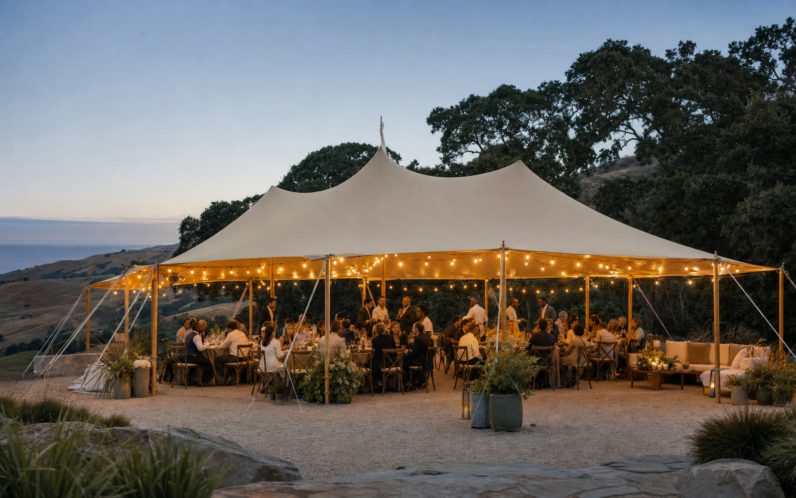 Guests enjoying a completed stretch tent event in California at blue hour