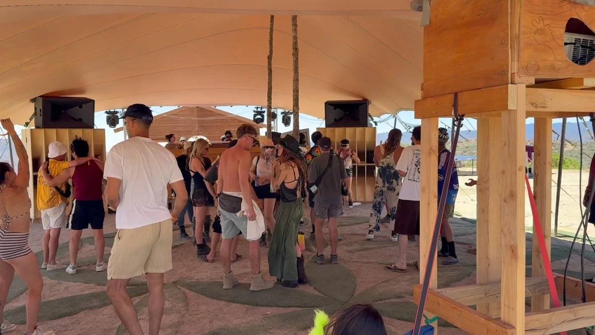 Guests dancing beneath a stretch canopy