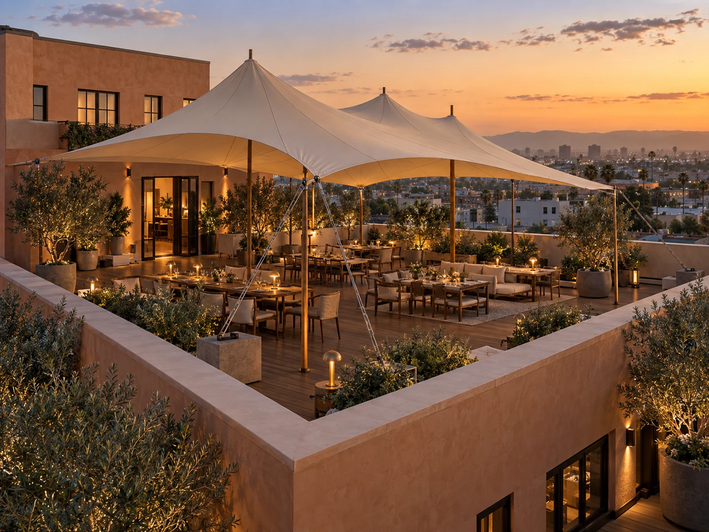 Large stretch canopy covering an outdoor terrace beside venue buildings