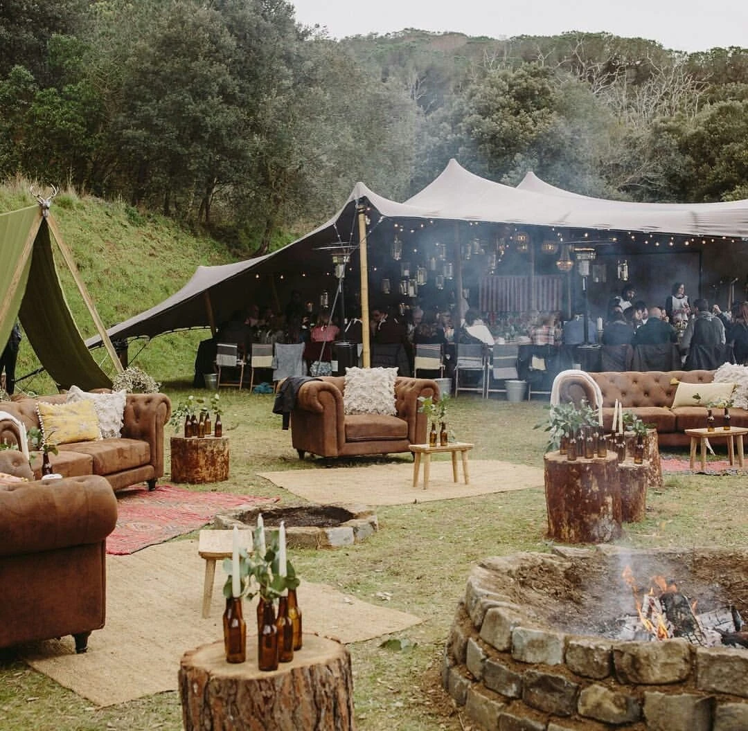 Soft seating beside a stretch canopy in a garden