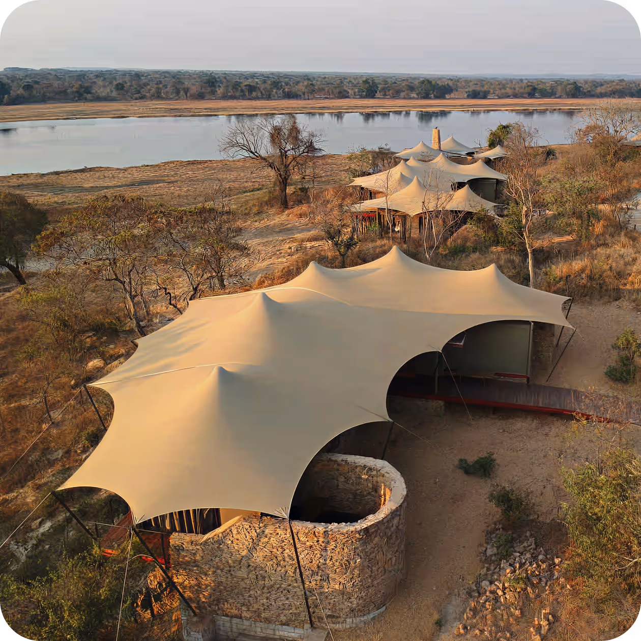 Stretch tent illuminated at sunset — creating an atmospheric outdoor space